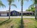 House exterior with palm trees and a driveway at 1877 Crowley E Cir, Longwood, FL 32779