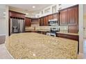 Kitchen with granite countertop and dark wood cabinets at 1877 Crowley E Cir, Longwood, FL 32779