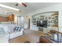 This sun-filled living room features a skylight, a large built-in bookcase, and comfortable seating arrangements at 2048 Gloria Oak Ct, Orlando, FL 32820