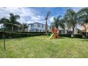 Spacious backyard with playground, volleyball net and lush lawn at 291 Lasso Dr, Kissimmee, FL 34747