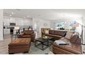 Open concept living room with a sectional sofa, coffee table and kitchen at 3220 Sweet Acres Pl, St Cloud, FL 34772