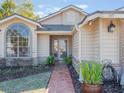 Front entryway with a walkway, landscaping, and a light fixture at 349 New Waterford Pl, Longwood, FL 32779
