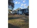 Single-story home with a covered car port, manicured lawn, and mature landscaping at 357 Wade Park Ct, Davenport, FL 33897