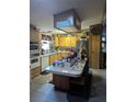 Functional kitchen with an eat-in island, stainless steel appliances, and ample cabinet space at 357 Wade Park Ct, Davenport, FL 33897