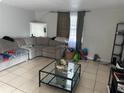 Spacious living room with grey sectional sofa and coffee table at 3614 Grice St, Apopka, FL 32703