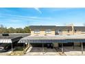View of the townhome community's parking area with covered carport at 5419 Fairwood Way # 305, Orlando, FL 32808