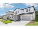 Beautiful home with a two-car garage and covered entry offers modern curb appeal at 5680 Brosnan Rd, St Cloud, FL 34771
