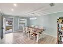 Bright dining room with a modern light fixture and a view to the front yard at 599 Alton Rd, Winter Springs, FL 32708