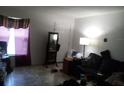 Living room with tiled floor, sofa, and floor lamp at 7628 Forest City Rd # 056 Aka H, Orlando, FL 32810