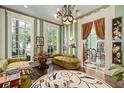 Green striped sitting room with ample natural light and unique decor at 817 Antonette Ave, Winter Park, FL 32789