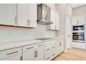White cabinets, quartz countertops, and stainless steel appliances at 1062 Liliana Dr, Deland, FL 32724