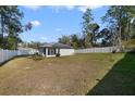 Large backyard with a spacious grassy area and privacy fence at 1630 W New York Ave, Orange City, FL 32763