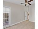 Spacious bedroom with tile floor, sliding door to patio, and ceiling fan at 1964 Lake Atriums Cir # 175, Orlando, FL 32839