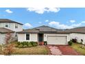 One-story house with solar panels and a brick driveway at 3037 Cassidy Ln, Haines City, FL 33844