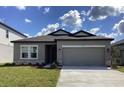 Single-story home features a two car garage and well-maintained lawn at 329 Conway Ave, St Cloud, FL 34771