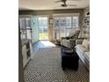 Bright living room with comfy seating, stylish rug, and access to a patio at 335 N Causeway # C23, New Smyrna Beach, FL 32169