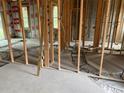 Interior framing and concrete flooring of new construction home at 339 Camellia Ct, Kissimmee, FL 34759