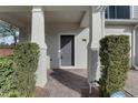 Townhome's front entrance with gray door and brick walkway at 4052 Falling Lilly Ct, Winter Springs, FL 32708
