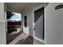 Covered front porch with gray door and brick flooring at 4052 Falling Lilly Ct, Winter Springs, FL 32708