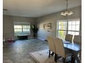 Bright dining area with large windows and tile flooring at 445 Kestrel Dr, Groveland, FL 34736