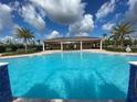 Community pool with a covered patio and palm trees at 4902 Chase Ct, St Cloud, FL 34772