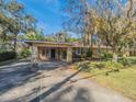 House exterior with stone accents and carport at 512 Jackson St, Eustis, FL 32726