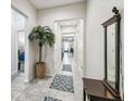 The entryway showcases a neutral color scheme, tiled flooring, and high ceilings, creating a welcoming atmosphere at 782 Grand Hilltop Dr, Apopka, FL 32703