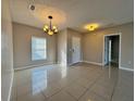 Living room with tile floors and a chandelier at 838 Oglethorpe Ct, Kissimmee, FL 34758