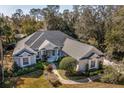 Single-Gathering home with gray roof, lush landscaping, and a paved driveway at 872 Edgeforest Ter, Sanford, FL 32771