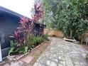 Spacious backyard featuring brick pavers, mature trees and foliage offering a private outdoor retreat at 1138 Easton St, Orlando, FL 32825