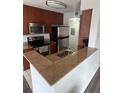 Modern kitchen featuring granite countertops and stainless steel appliances at 11568 Westwood Blvd # 1034, Orlando, FL 32821
