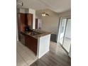 Open kitchen with granite counters, stainless steel appliances, and breakfast bar at 11568 Westwood Blvd # 1034, Orlando, FL 32821