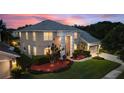 Two-story house with a three-car garage and manicured lawn at 13005 Islamorada Dr, Orlando, FL 32837