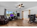 Living room with hardwood floors, a TV, and access to other rooms at 134 W Sunset St, Groveland, FL 34736