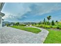 Spacious backyard with a patio, landscaping, and a view of the lake at 16000 Volterra Pt, Montverde, FL 34756