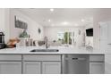 Modern kitchen with quartz countertops, stainless steel dishwasher, and open layout at 2033 Canny Cv, Winter Park, FL 32792