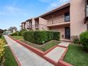 Side view of condo building showcasing landscaping and walkway at 230 La Casa # 230, Lake Wales, FL 33898