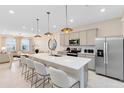 Modern kitchen with center island, stainless steel appliances, and white quartz counters at 2736 Clear Night Ave, Kissimmee, FL 34744