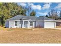 Newly built home with gray exterior and white garage door at 43 Water Track Dr, Ocala, FL 34472