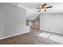 Spacious living room with grey walls, carpeted floors, and ceiling fan at 43 Water Track Dr, Ocala, FL 34472
