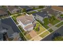 Aerial view of the house showing its location in a well-maintained community with lush landscaping and green lawns at 4455 Indigo Sky Ln, Kissimmee, FL 34744