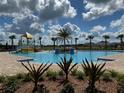 Community pool with a water playground and surrounding landscaping at 5034 Down Ct, St Cloud, FL 34772