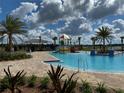 Community pool featuring a water playground and brick pavers at 5034 Down Ct, St Cloud, FL 34772