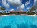 Resort-style pool with a covered patio and palm trees at 5034 Down Ct, St Cloud, FL 34772