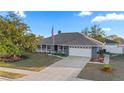 Inviting single Gathering home featuring a well manicured lawn, lush landscaping and a long driveway at 657 Hunters Run Blvd, Lakeland, FL 33809