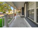 Spacious front porch featuring white marble floors, exterior home accents and charming columns at 657 Hunters Run Blvd, Lakeland, FL 33809