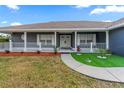 Inviting front yard, complete with a sidewalk leading to the front door and lush landscaping at 657 Hunters Run Blvd, Lakeland, FL 33809