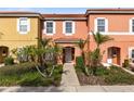 Two-story townhome with front yard landscaping and walkway at 8519 Bay Lilly Loop, Kissimmee, FL 34747