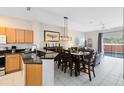 Open kitchen with granite counters, wood cabinets, and breakfast bar at 8519 Bay Lilly Loop, Kissimmee, FL 34747