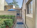 View of townhouse gated entry with walkway and landscaping at 925 Wintergreen Blvd, Fern Park, FL 32730